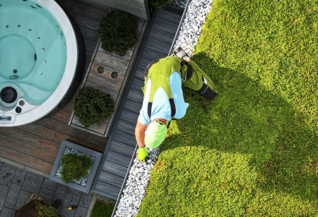 Landscaper Finishing Green Roof Installation. Perennial Succulents