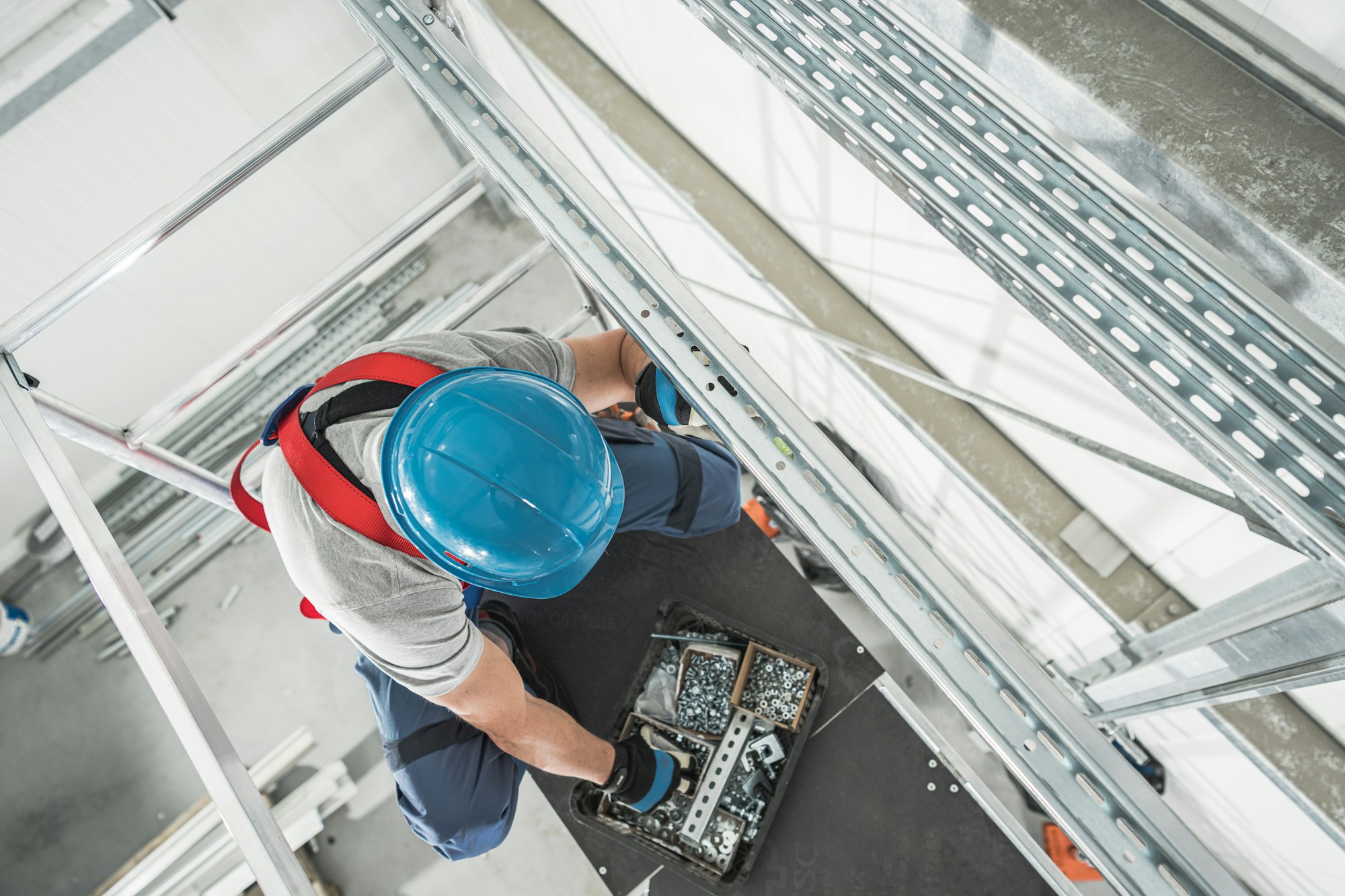 Warehouse Heating and Cooling Systems Technician on Scaffolding